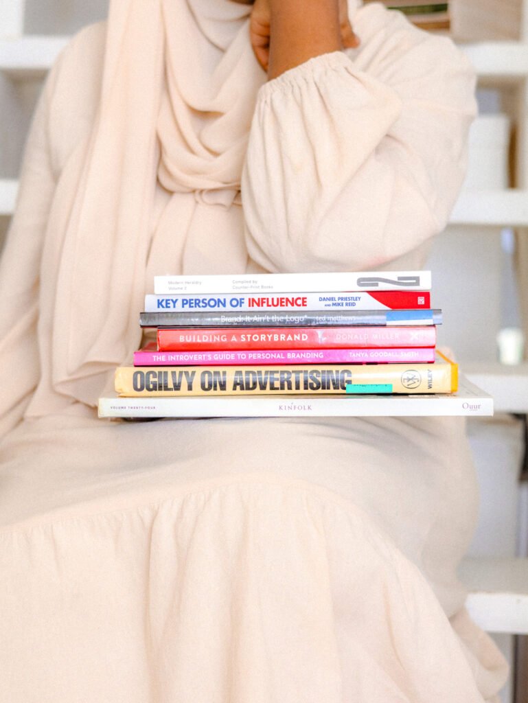 Zuhura Hassan holding books related to brand strategy